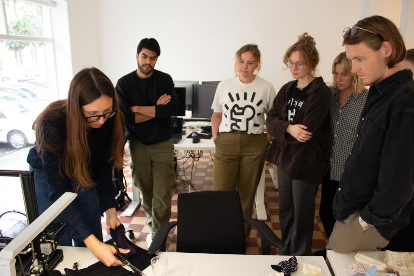 Workshop participants watching a 4D printing demonstration